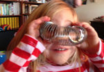 Child looking through slinky